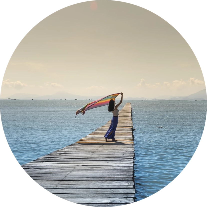 Woman on dock with rainbow flag